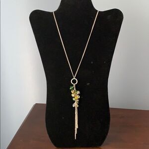 Silver necklace with colored bead pendant.